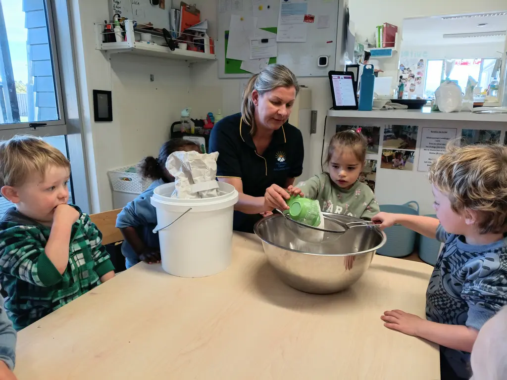 Kaiako supporting children with baking at Highfield Haven