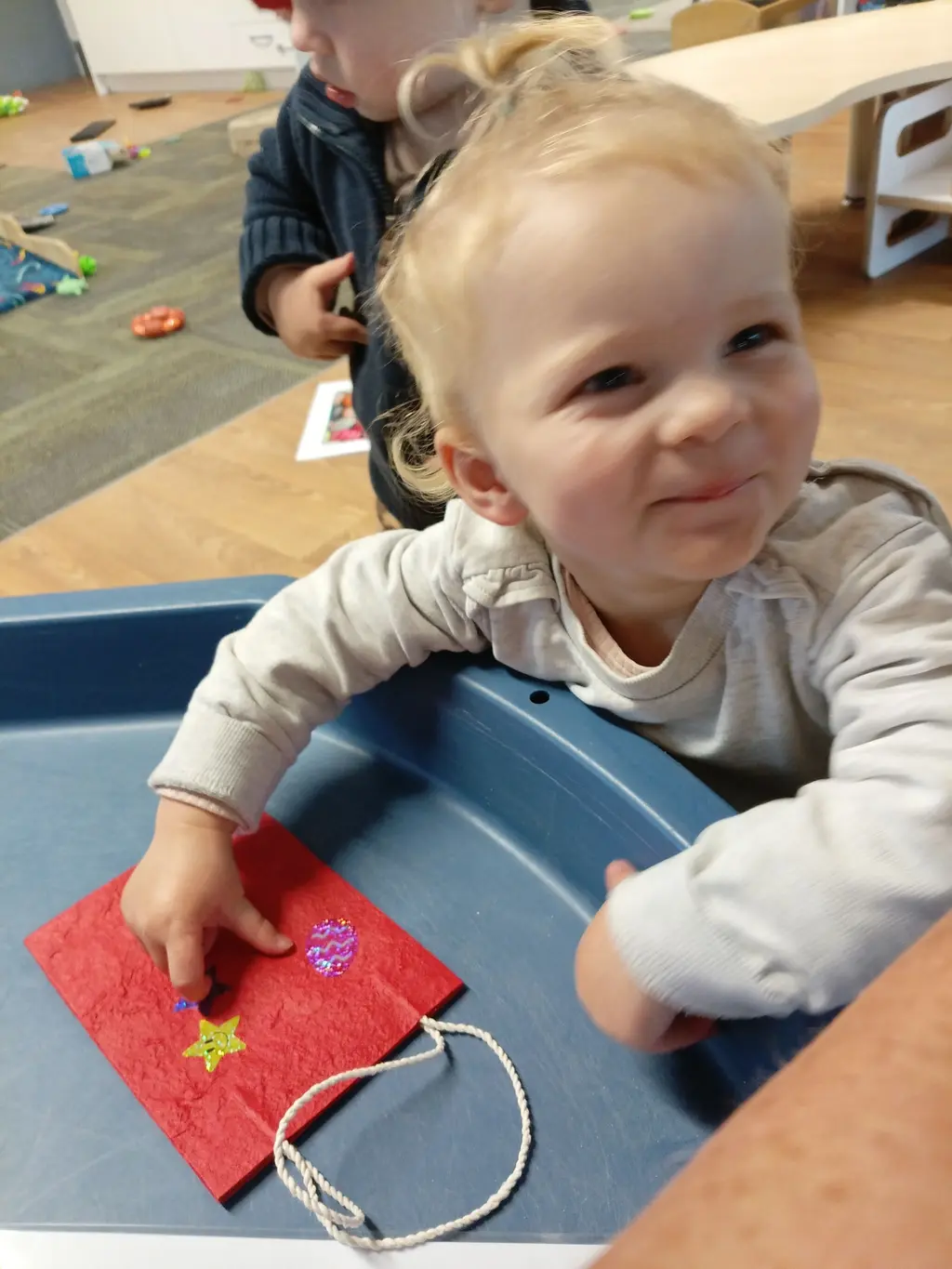 A young child exploring outdoor drawing play at Highfield Haven