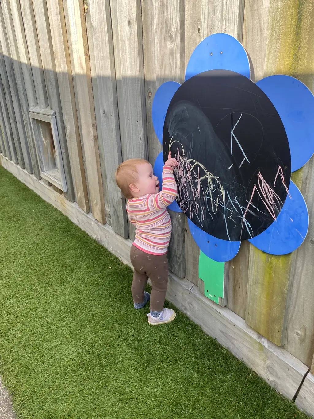 A toddler enjoying a quiet creative moment at Highfield Haven